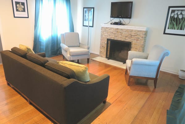 Cozy common area with chairs and a fireplace
