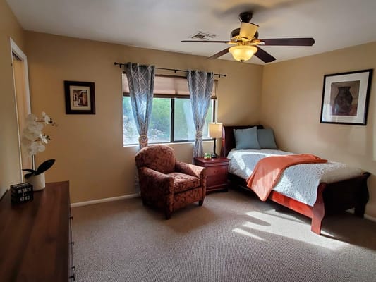 Cozy private room with a bed and chair