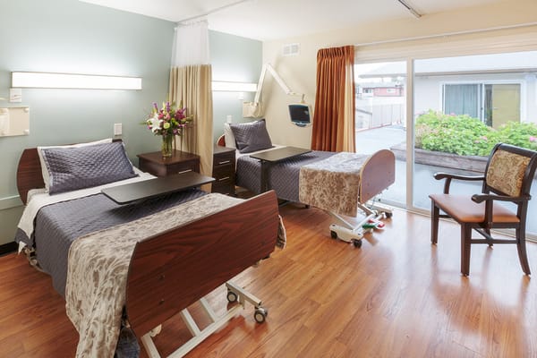 Private resident room with two beds and patio access