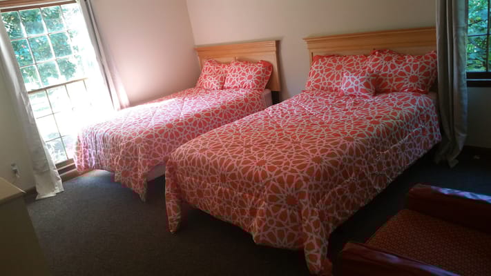 Shared room with two beds and bright decor