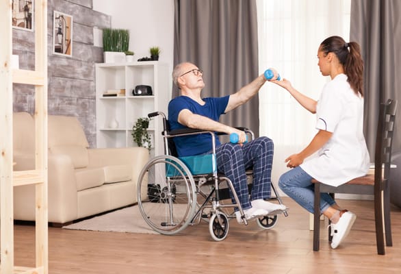 Therapist assisting a resident with weights in an indoor setting