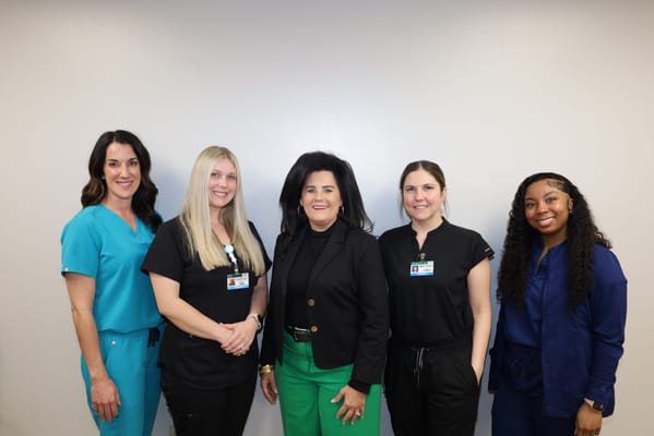 Staff members posing together in a facility