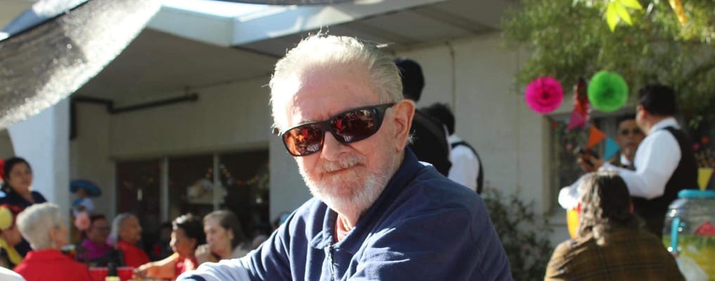 Senior resident wearing sunglasses at a social gathering