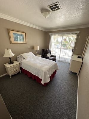 Private resident room with a bed and chair