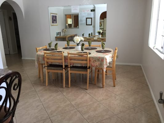 Dining area set up for a meal with floral tablecloth