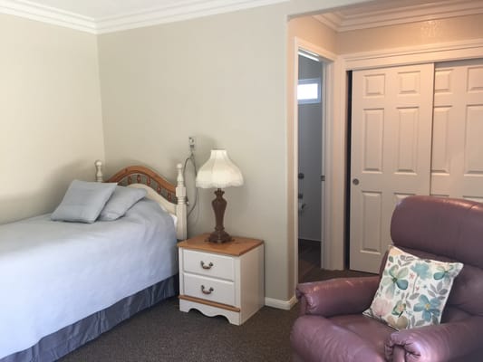 Cozy private resident room with bed and furniture