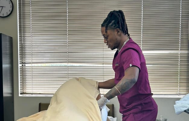 Staff member making a bed in a resident room