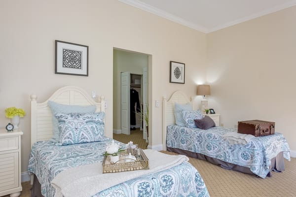 Cozy resident bedroom with two beds and decor