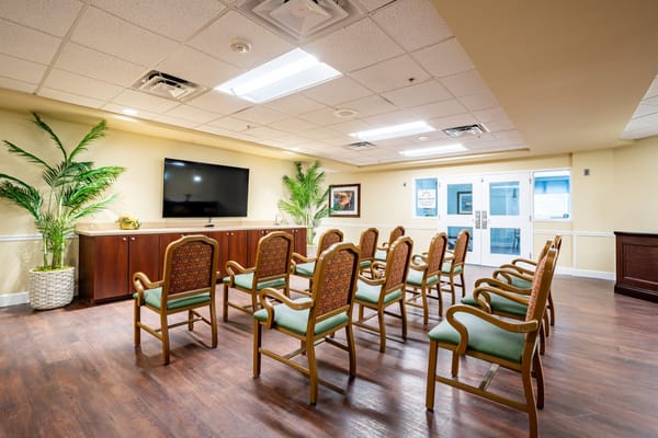 Interior view of a common area with chairs and a TV