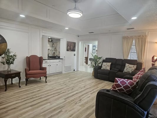 Common area with seating and decor in an assisted living facility