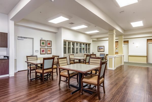 A spacious dining area with tables and chairs at Greenridge Place.