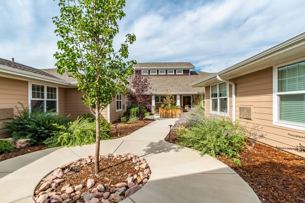 A landscaped courtyard with trees and pathways at Greenridge Place