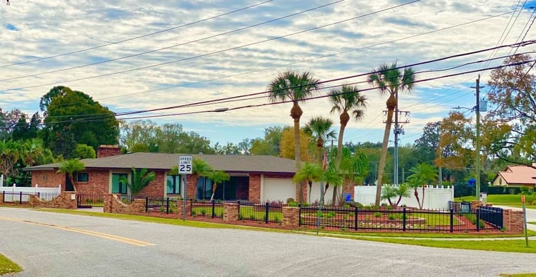 Exterior view of the Haven ALF building surrounded by palm trees
