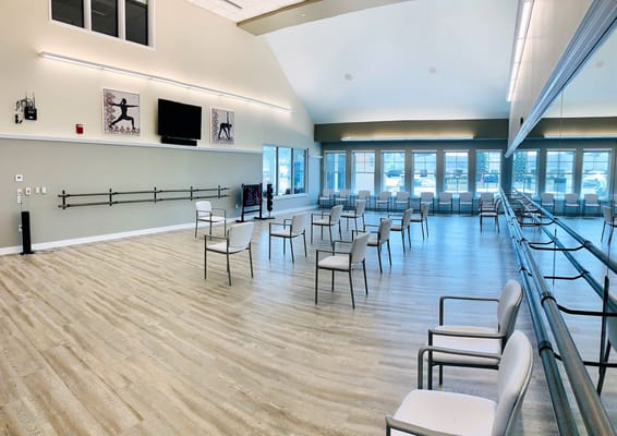 Bright interior activity room with scattered chairs