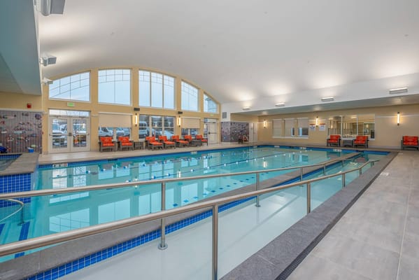 Indoor swimming pool area with seating
