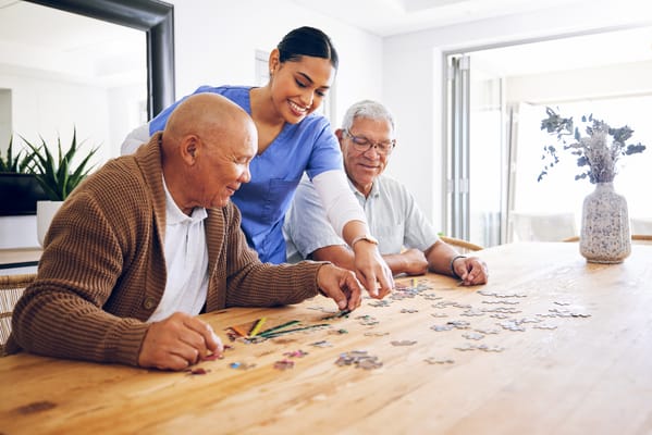 Residents and staff enjoying a puzzle activity together