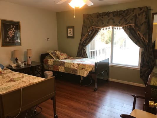 Private resident room with beds and natural light
