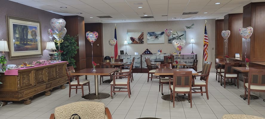 Common area decorated for a celebration with balloons.