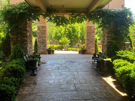 Pathway leading to a lush outdoor garden area
