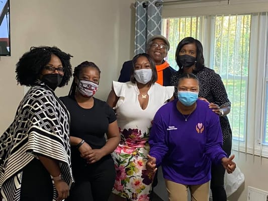 Group of staff members posing together in facility