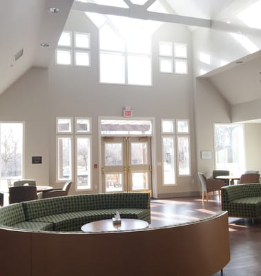 Bright and airy common area with large windows and seating arrangement