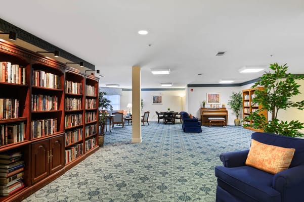 Interior view of a cozy common area with bookshelves