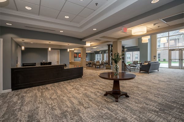 Spacious lobby area with a reception desk and seating at Kingsley Senior Living