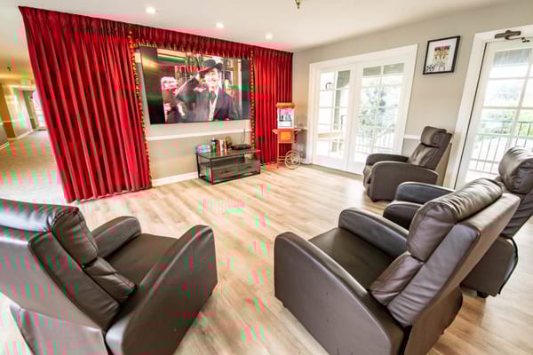 Comfortable common area with recliners and a TV
