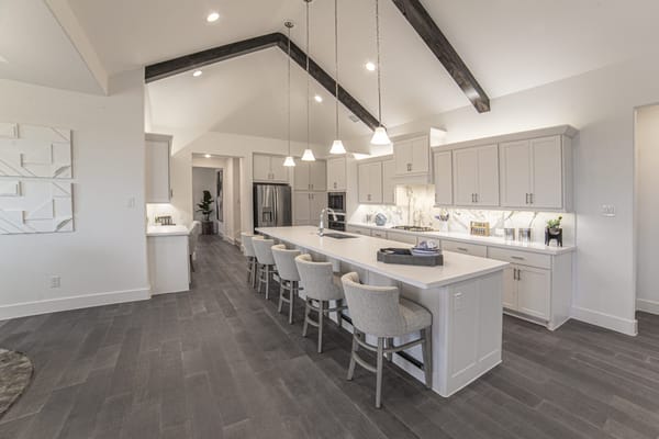 Spacious modern kitchen with island seating at Ladera at Prosper