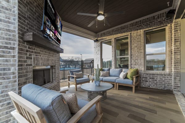 Cozy patio lounge with seating and a TV