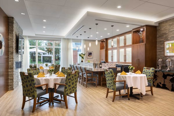 Modern dining area with bright decor and tables set for dining