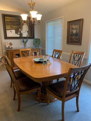 Wood dining table with chairs and decorative items in a dining room