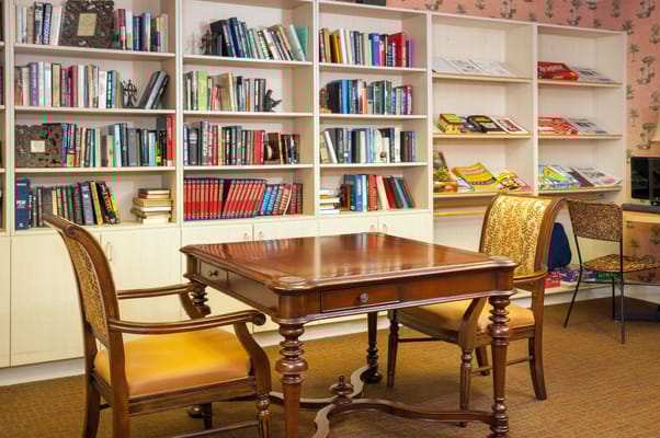 Well-organized interior library area with books and seating