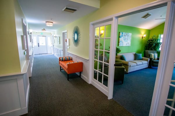 Interior hallway leading to a communal area with seating