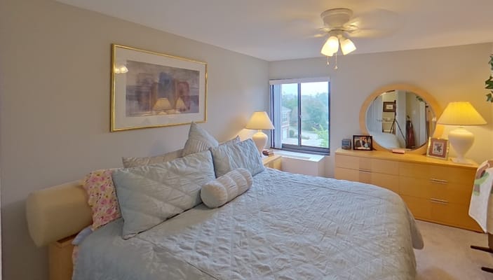 Cozy bedroom with a bed, lamps, and a window