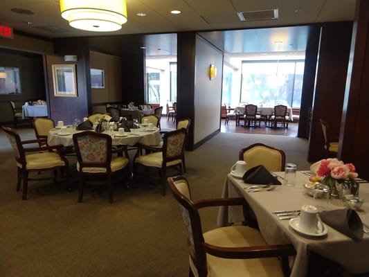 Dining room set up for a meal with floral centerpieces