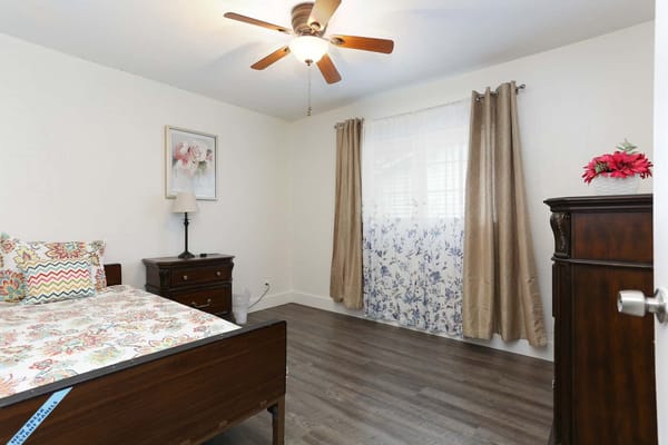 Bright, well-decorated resident room with floral accents