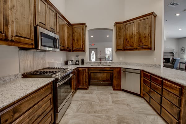 Modern kitchen area with wooden cabinets and appliances