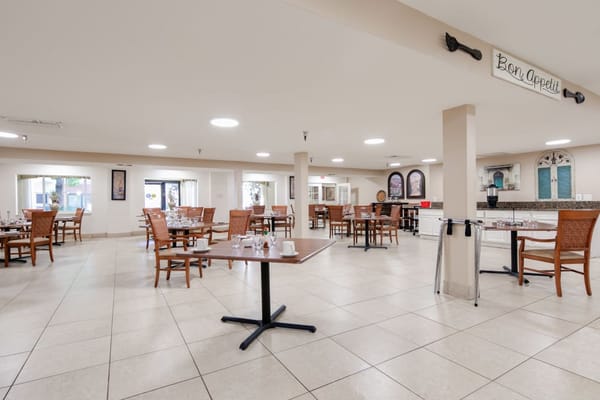 Spacious dining room with wooden tables and chairs