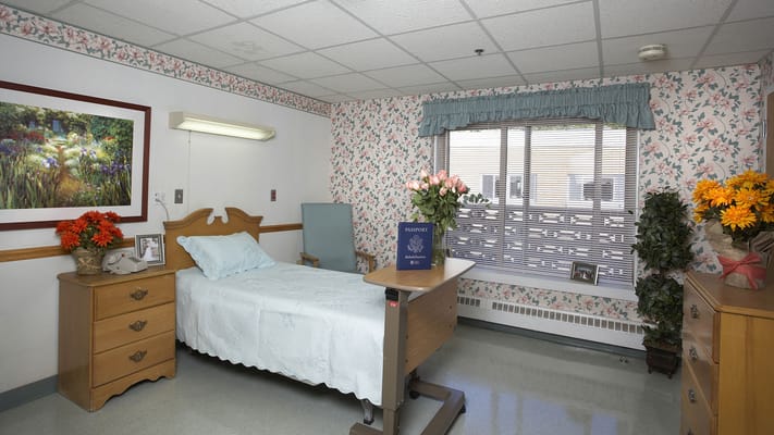 Private resident room with floral decor and a bed