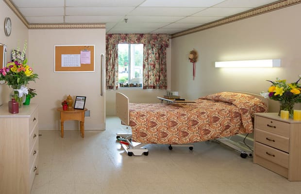 Cozy resident room with floral decor and a bed