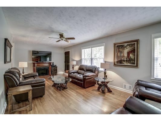 Cozy common area with leather seating and a television