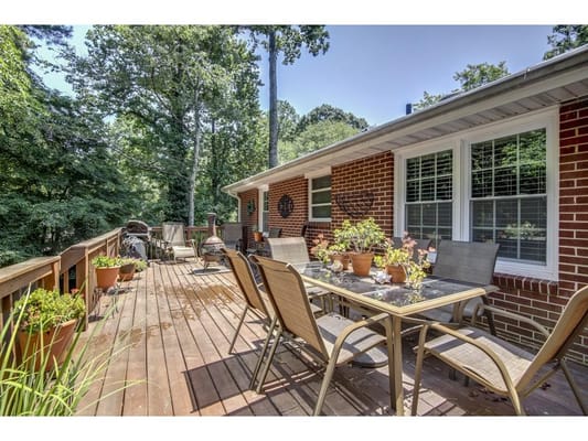 Outdoor patio area with seating and greenery