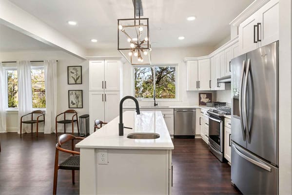 Bright and modern kitchen space with white cabinetry