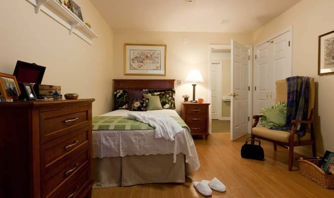 Cozy private resident room with bed and furnishings