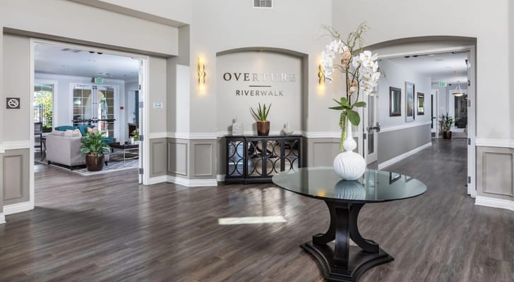 Bright interior lobby with a decorative table and plants