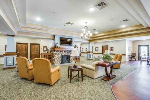 Bright common area with comfortable seating and a fireplace