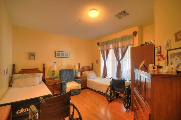 Private resident room with two beds and wheelchairs