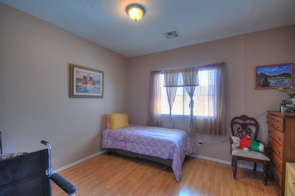 Cozy private resident room with bed and chair