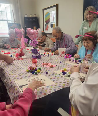 Residents engaged in a craft activity at a table